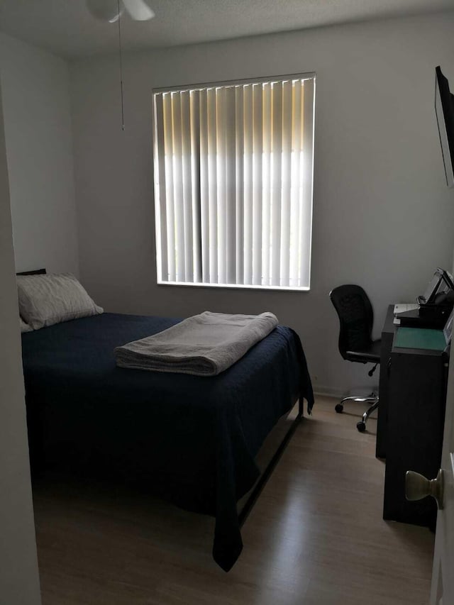 bedroom featuring ceiling fan and light hardwood / wood-style floors