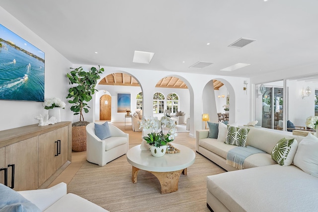 living room with plenty of natural light and light hardwood / wood-style floors