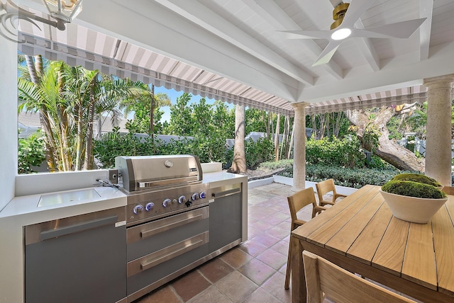 view of patio with ceiling fan and area for grilling