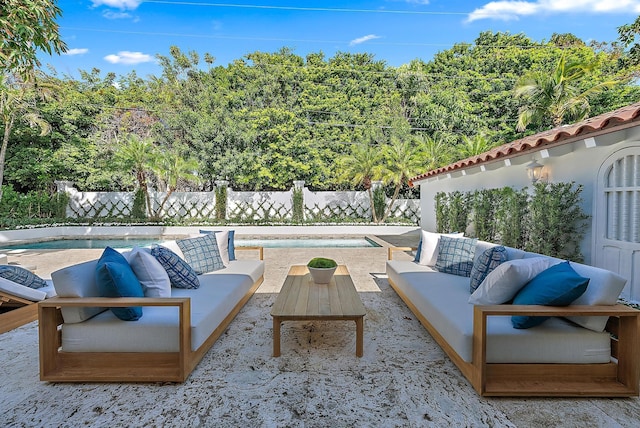 view of patio / terrace with an outdoor living space and a fenced in pool