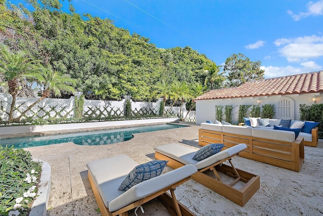 view of pool with an outdoor living space and a patio