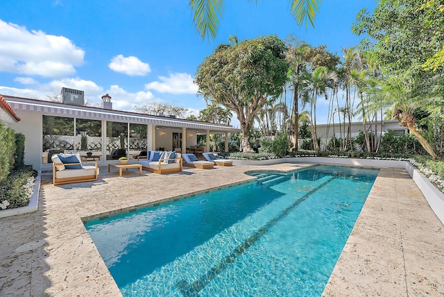 view of swimming pool with outdoor lounge area and a patio