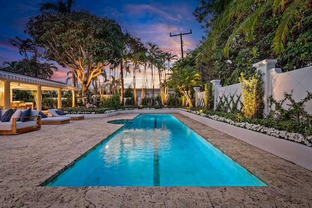 view of pool at dusk