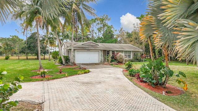 view of front of house with a garage and a front lawn