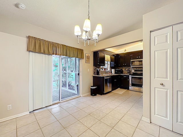 kitchen featuring backsplash, light tile patterned floors, appliances with stainless steel finishes, decorative light fixtures, and dark brown cabinetry