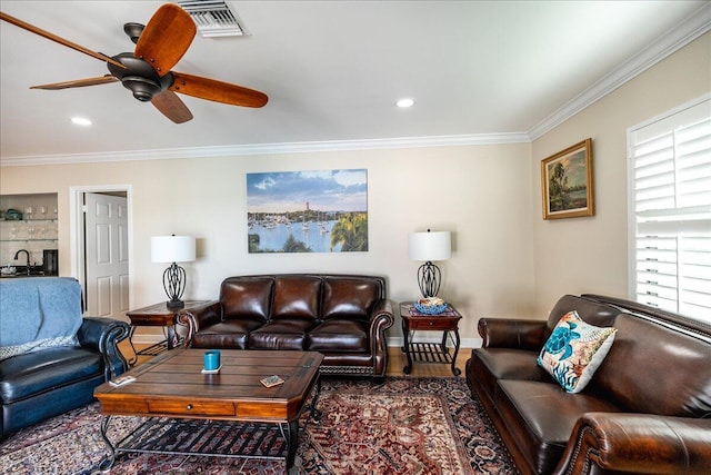 living room with crown molding, ceiling fan, and wood-type flooring