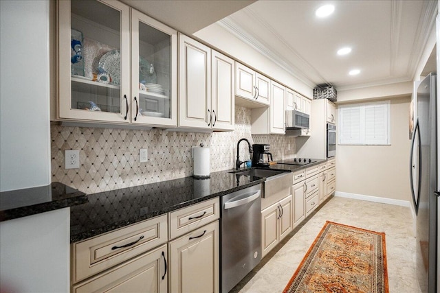 kitchen featuring sink, crown molding, decorative backsplash, dark stone countertops, and appliances with stainless steel finishes