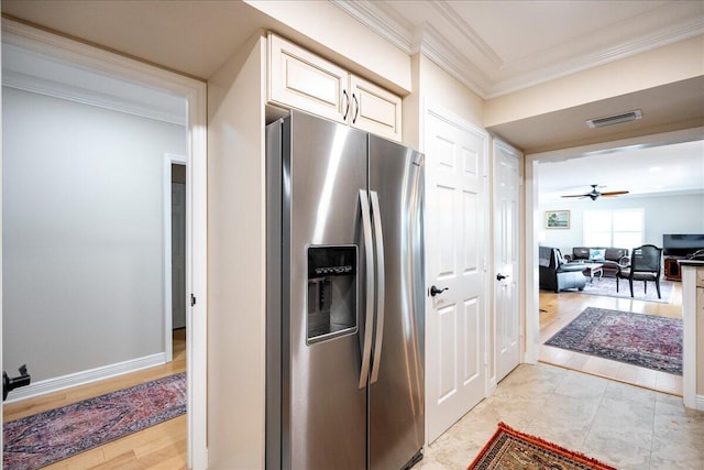 kitchen with stainless steel refrigerator with ice dispenser, ceiling fan, crown molding, cream cabinets, and light hardwood / wood-style floors