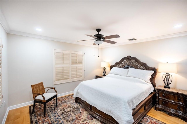 bedroom featuring ceiling fan, crown molding, and hardwood / wood-style flooring