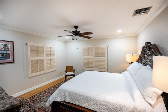 bedroom with ceiling fan, hardwood / wood-style floors, and crown molding