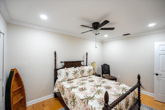 bedroom featuring ceiling fan, light hardwood / wood-style floors, and ornamental molding