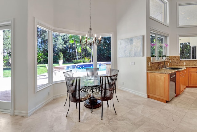 dining room featuring a notable chandelier and sink