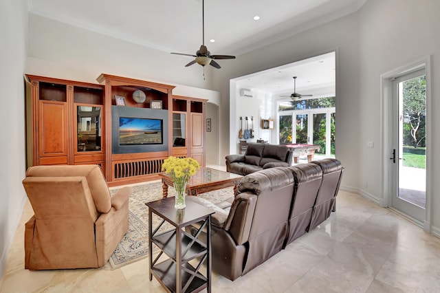 living room with ceiling fan and ornamental molding