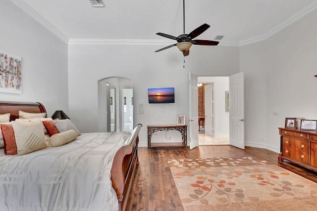 bedroom with hardwood / wood-style floors, ceiling fan, and ornamental molding