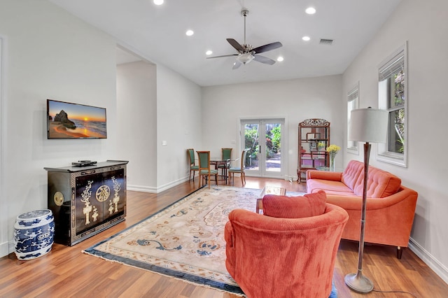 living room with ceiling fan, french doors, and hardwood / wood-style floors