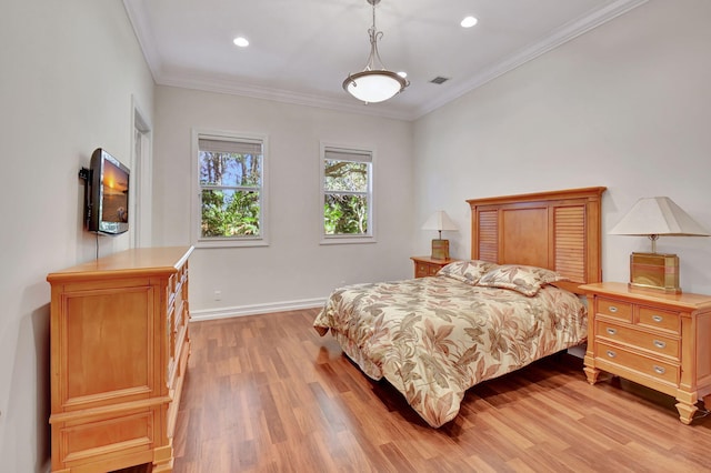 bedroom with light wood-type flooring and crown molding