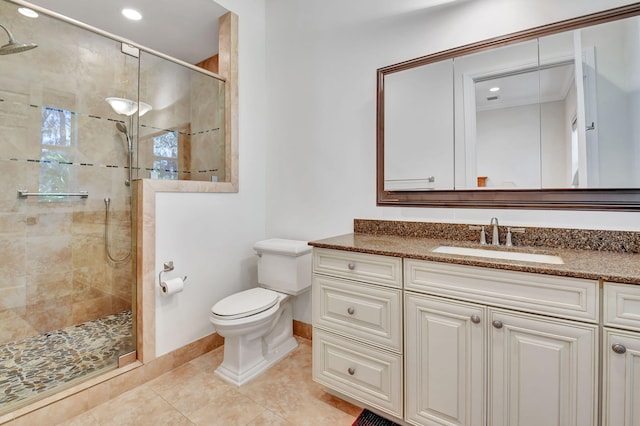 bathroom featuring tile patterned flooring, vanity, an enclosed shower, and toilet