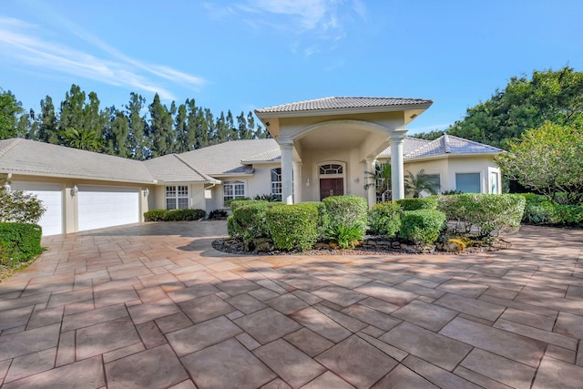 mediterranean / spanish home with a garage