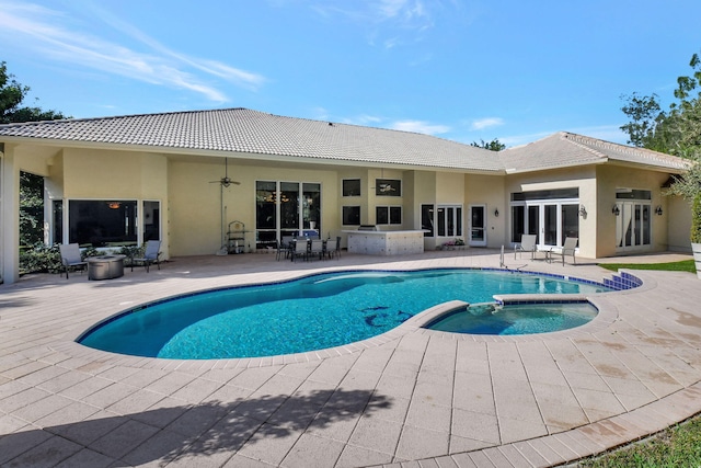 view of swimming pool featuring an in ground hot tub, a patio, and ceiling fan