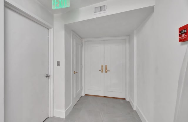 hall with light tile patterned floors