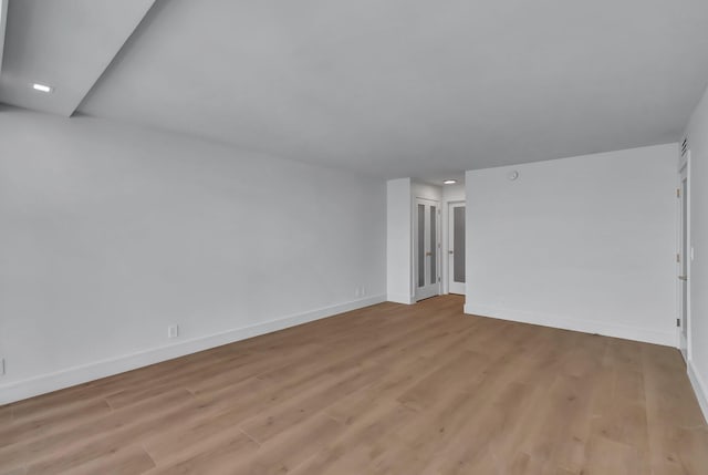 spare room with light hardwood / wood-style floors