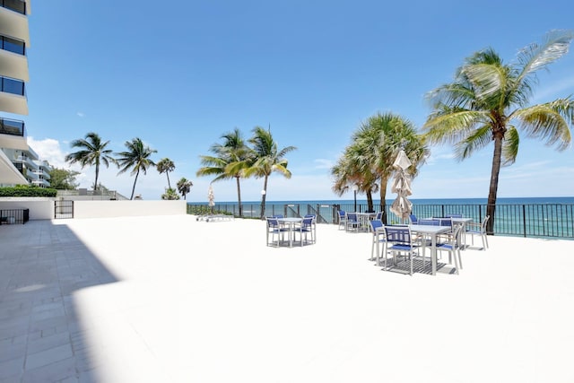 exterior space with a water view and a beach view