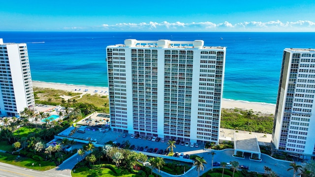 drone / aerial view featuring a water view and a beach view