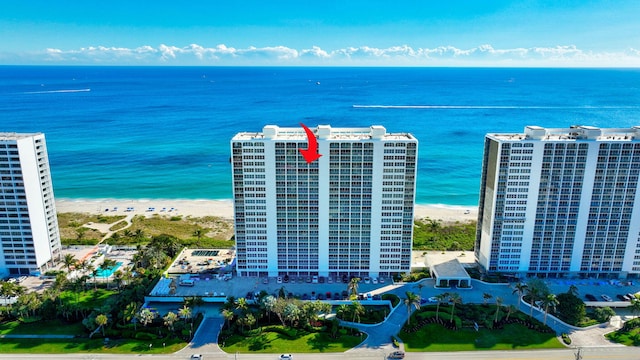 birds eye view of property featuring a view of the beach and a water view