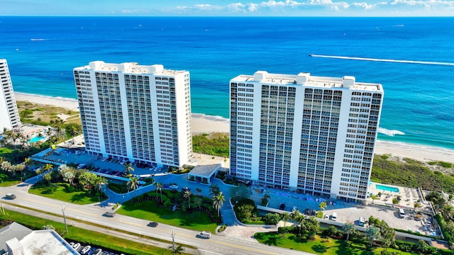 drone / aerial view with a water view and a beach view