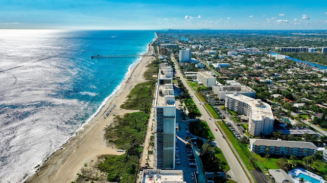 bird's eye view with a water view and a beach view