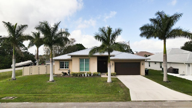 view of front of house with a front yard and a garage