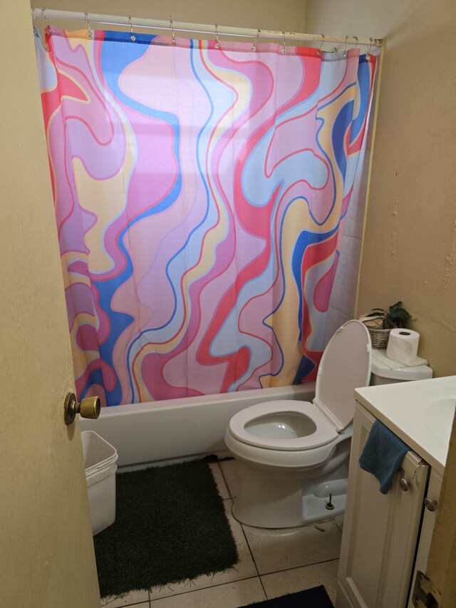 full bathroom featuring tile patterned floors, vanity, toilet, and shower / bath combo with shower curtain