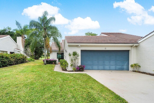 view of front of property with a garage and a front yard