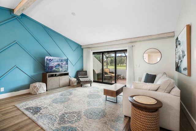 living room featuring hardwood / wood-style floors and vaulted ceiling with beams