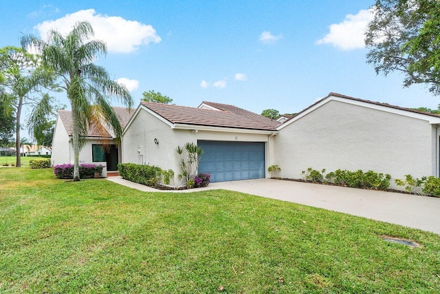 view of front facade with a front yard and a garage