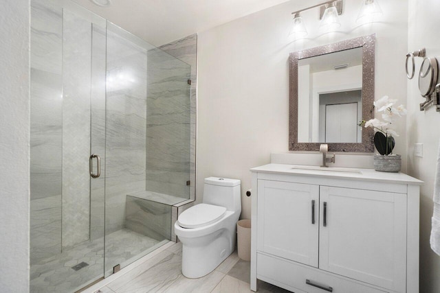 bathroom with vanity, a shower with shower door, and toilet