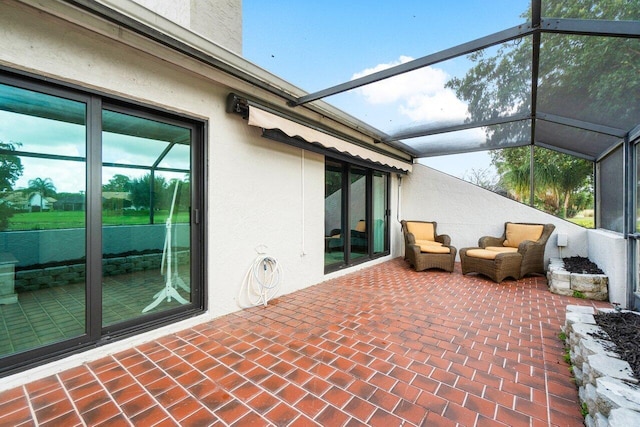 view of patio / terrace featuring glass enclosure