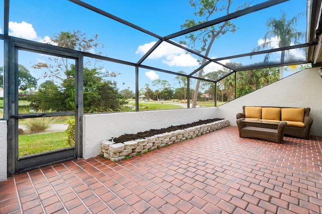 view of patio featuring glass enclosure