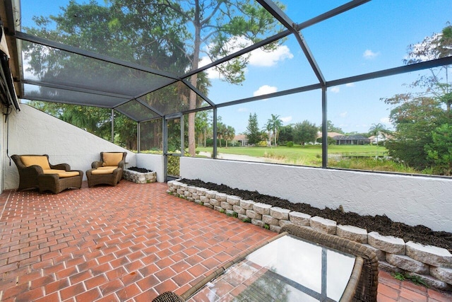 view of patio featuring glass enclosure