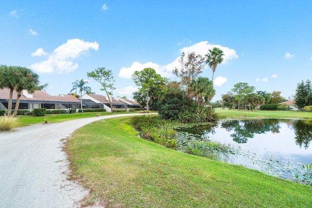 exterior space featuring a lawn and a water view