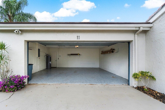 garage featuring electric panel and water heater