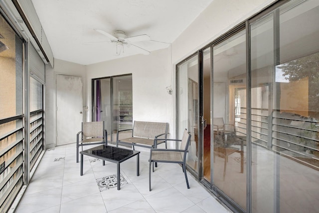 sunroom featuring ceiling fan