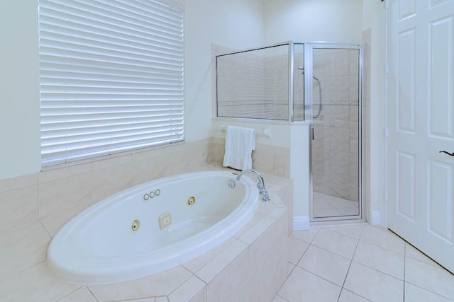 bathroom with tile patterned floors, a stall shower, and a whirlpool tub