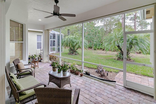 sunroom featuring ceiling fan