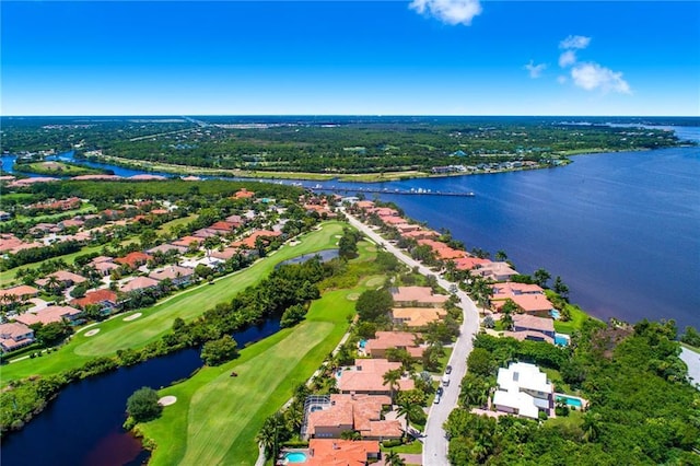 drone / aerial view with a water view and golf course view