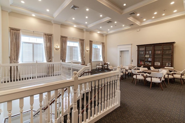 hallway with crown molding, a high ceiling, visible vents, and coffered ceiling