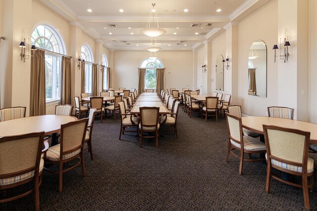 dining space with visible vents, ornamental molding, recessed lighting, a high ceiling, and dark colored carpet