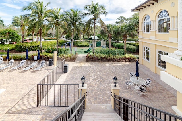 surrounding community featuring a patio and fence