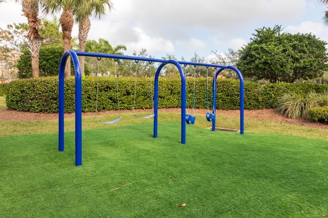 community jungle gym with a lawn