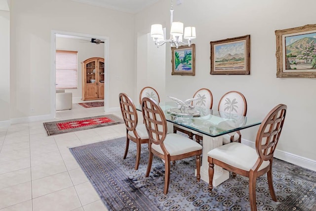 dining space featuring an inviting chandelier, light tile patterned floors, and baseboards